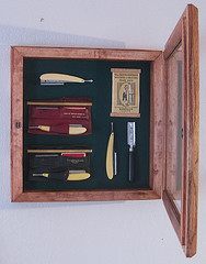 Cabinet displaying antique razors